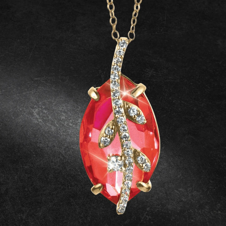 Fire Vine Pendant featuring a sterling silver gold-plated vine design with sparkling crystals set over a vibrant red gemstone, elegantly crafted for women’s jewelry.