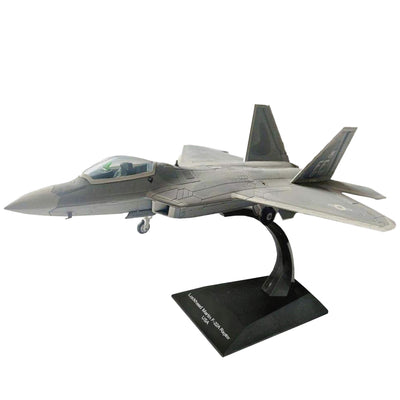 F-22A Raptor fighter jet model displayed on a black stand with twin tail fins, cockpit canopy, swept wings, and detailed gray military styling