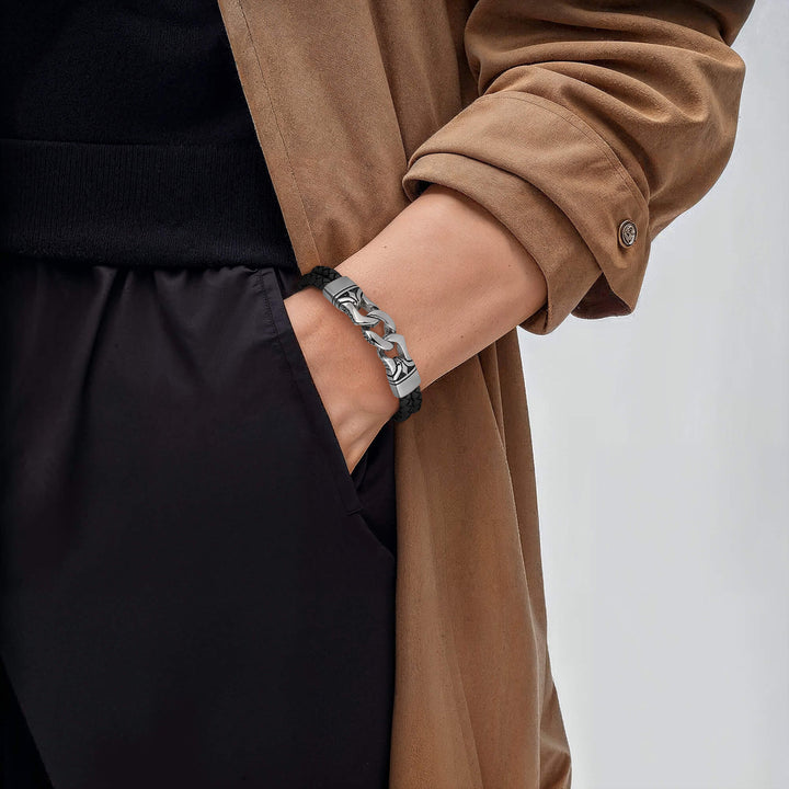 Horizon Men's Black Bracelet featuring a black leather band with silver chain accents worn on a male wrist paired with a brown coat and black pants.