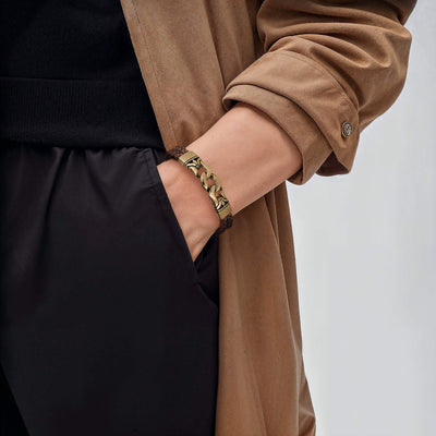 Horizon Men's Brown Bracelet featuring a leather band and gold plating, worn on a wrist paired with a casual brown coat and black clothing for a stylish, modern look.