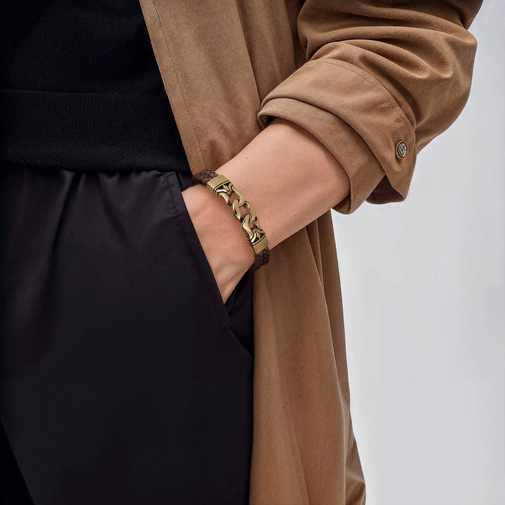 Horizon Men's Brown Bracelet featuring a leather band and gold plating, worn on a wrist paired with a casual brown coat and black clothing for a stylish, modern look.