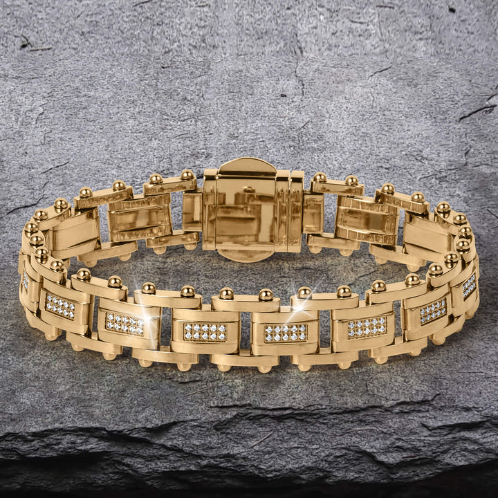 Imperial Link Bracelet featuring a gold-toned metal design with rectangular links adorned with small sparkling stones, displayed on a textured stone surface.