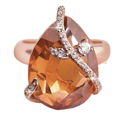 Fire and Ice Ring featuring a teardrop-shaped amber gemstone set in sterling silver with rose gold plating, accented with small clear crystals for a feminine touch.