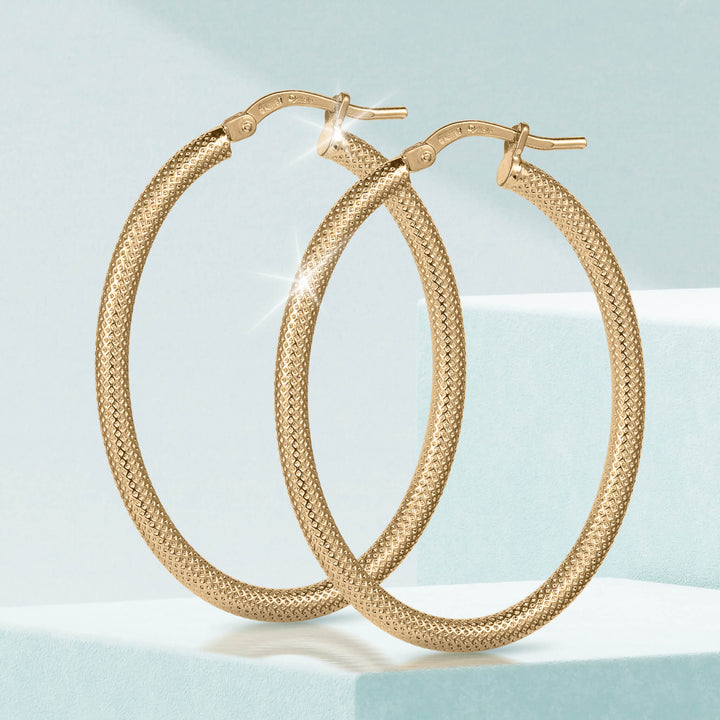 Lucente Hoop Oval Earrings in textured gold-tone metal with an elegant oval shape, perfect for adding a sophisticated touch to any jewelry collection.