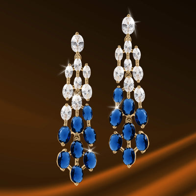 Elegant gold-tone chandelier earrings featuring sparkling clear and deep blue gemstones, part of the Royal Tide Collection jewelry selection.