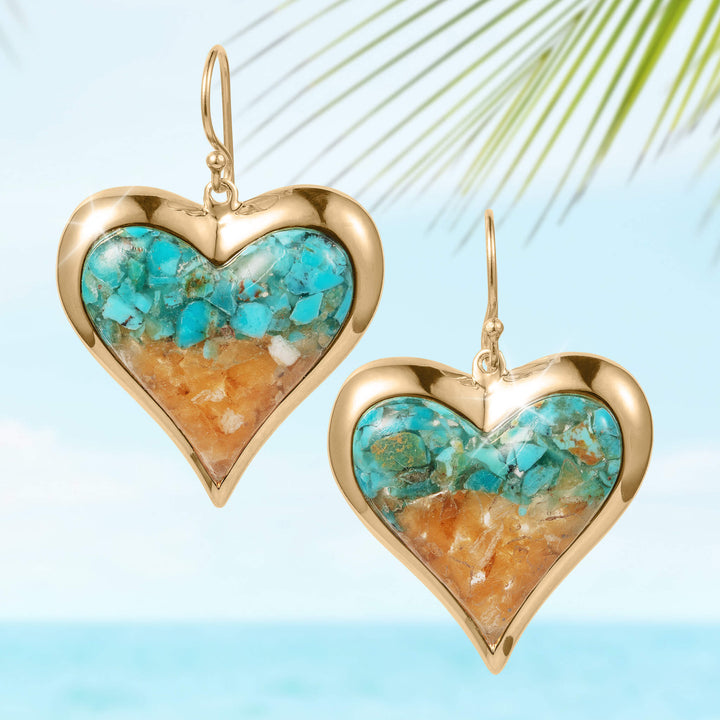 Elegant heart-shaped earrings from the Sunlit Shore Heart Collection featuring gold-tone frames with turquoise and sandy-colored inlays, evoking a coastal charm.