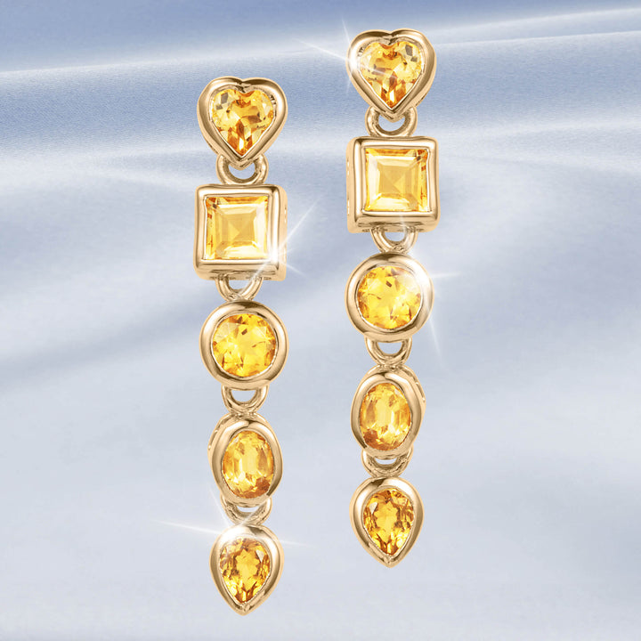 Citrine Symphony Earrings with gold tone drop designs featuring heart, square, and round citrine gemstones in a sparkling linked arrangement