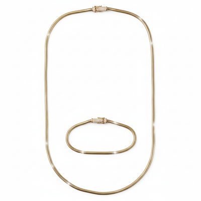 Gold necklace and bracelet set on a white background