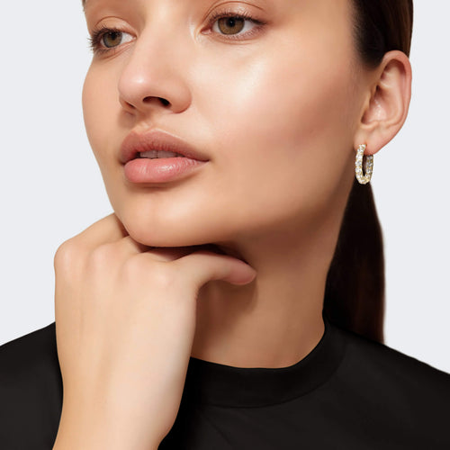 Woman wearing gold earrings