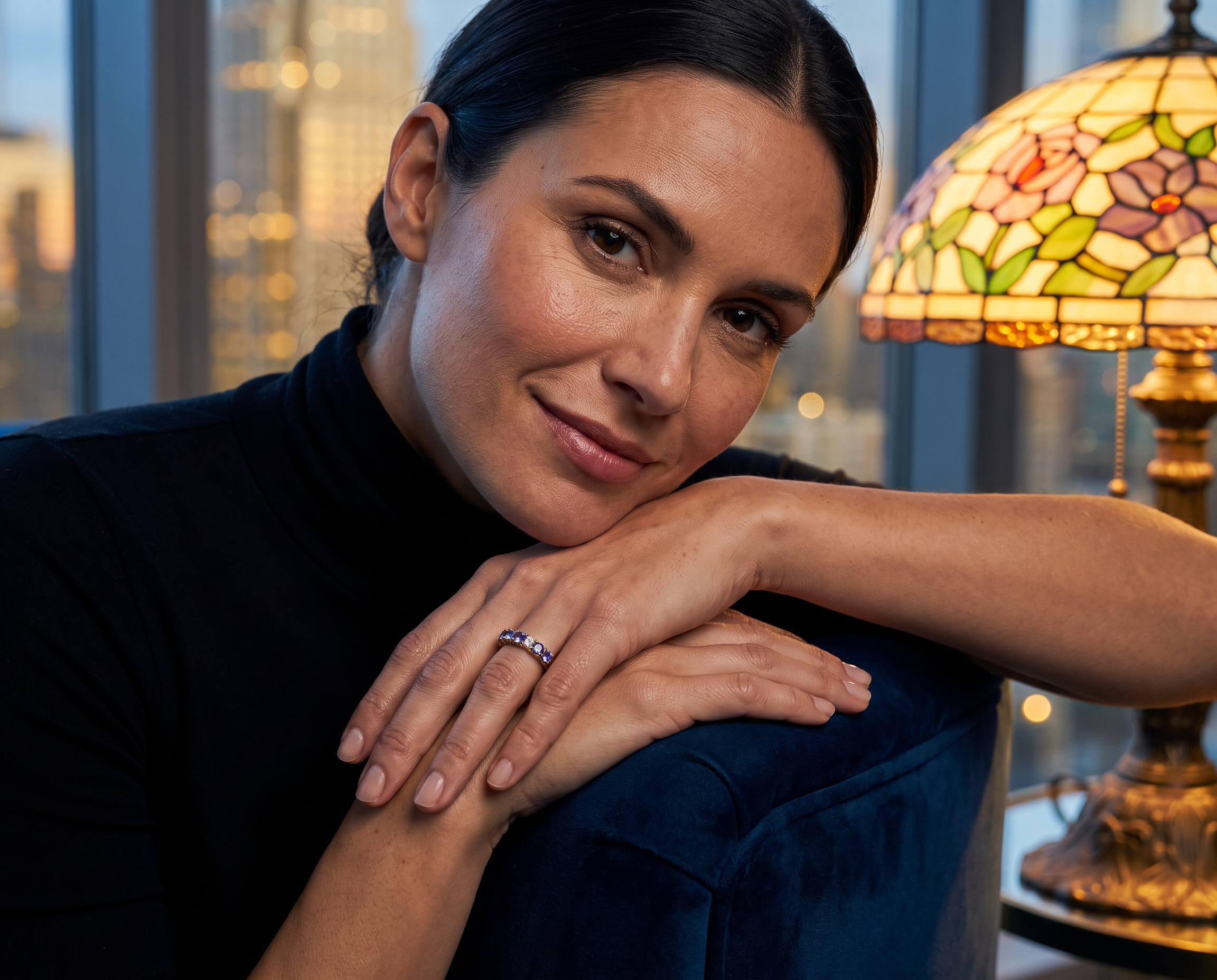 Milele Tanzanite Ring worn by a woman resting her hands on a chair in a warmly lit room Up To 75% Off Retail