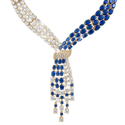 Royal Tide Necklace featuring an intricate design with alternating rows of sparkling clear and deep blue gemstones set in gold, creating an elegant and luxurious look.