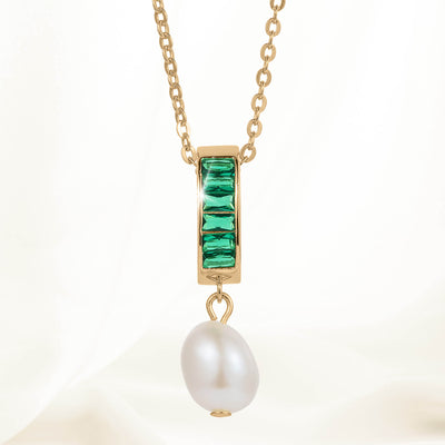 Elegant gold chain necklace featuring a rectangular pendant with green gemstones and a dangling white pearl from the Pearl Radiance Collection