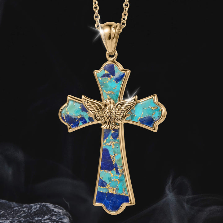 Wings Of Freedom Pendant featuring a gold cross with turquoise and navy inlaid stones and a detailed gold eagle with outstretched wings at the center, hanging on a matching gold chain.