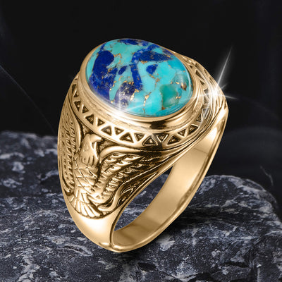 Gold ring from the Wings Of Freedom Collection featuring intricate eagle engraving and a polished blue-green stone centerpiece, symbolizing strength and elegance.