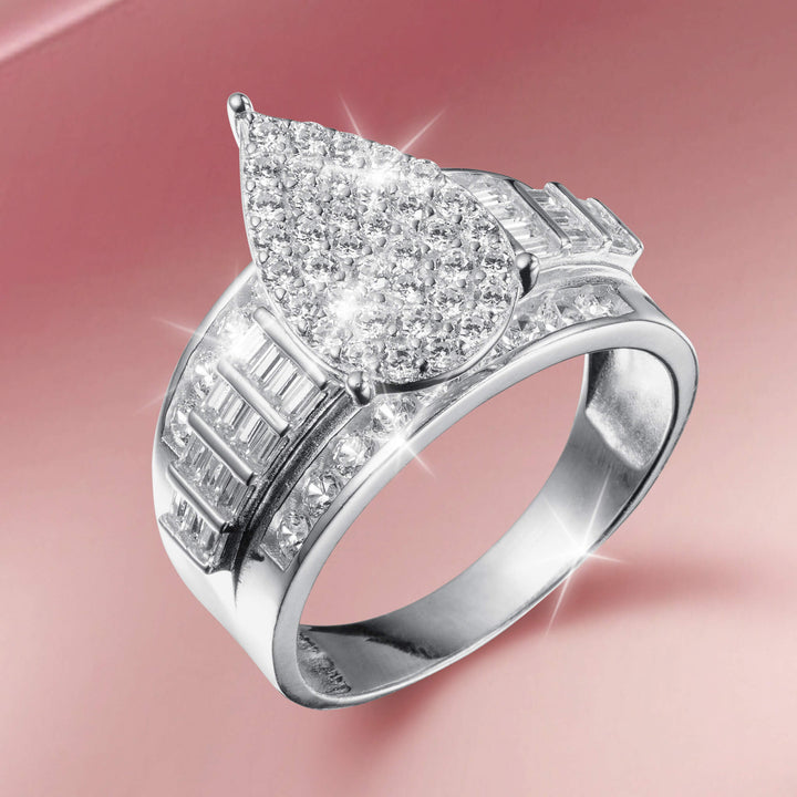 Lustrefall Ring featuring a pear-shaped cluster of sparkling diamonds set in polished silver with additional baguette and round cut stones accentuating the wide band design.