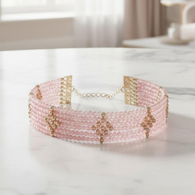 Rosa Cascade Bracelet featuring delicate pink gems with rose gold plating, designed for women, displayed on a marble surface showcasing elegant craftsmanship.