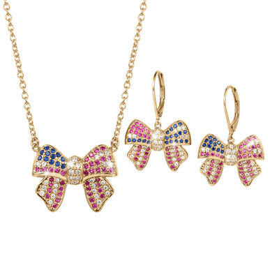 Gold bow-shaped necklace and matching earrings set adorned with blue, pink, and white gemstones from the Heritage Bow Collection, elegant jewelry perfect for special occasions.