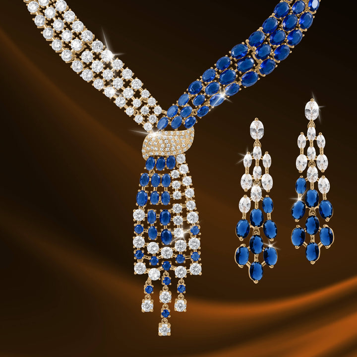 Elegant Royal Tide Collection necklace and matching earrings featuring blue gemstones and sparkling clear crystals in a sophisticated design.