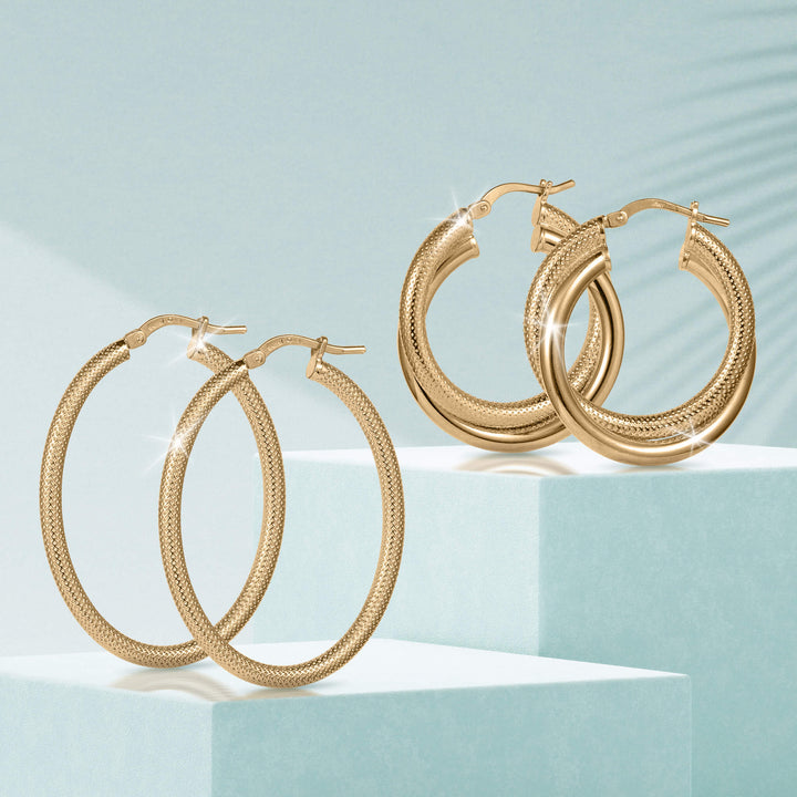 Lucente Hoop Set featuring two pairs of textured gold-tone hoop earrings displayed on light blue geometric pedestals with subtle sparkling highlights.
