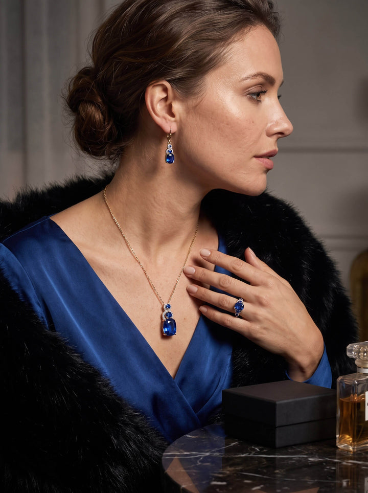 Elara Sapphire Ring with a deep blue gemstone worn by a woman in elegant attire alongside matching sapphire jewelry Up To 75% Off Retail