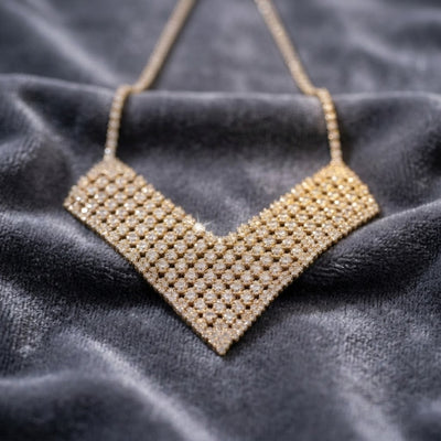 Glamorama Gold Statement Necklace featuring white base metal with gold plating, designed for women, displayed on a dark textured fabric background.