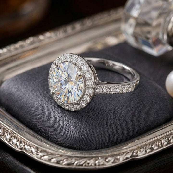 Versailles Rhodium Ring featuring a large round center gemstone surrounded by smaller stones, crafted in sterling silver with rhodium plating, designed for women’s jewelry.