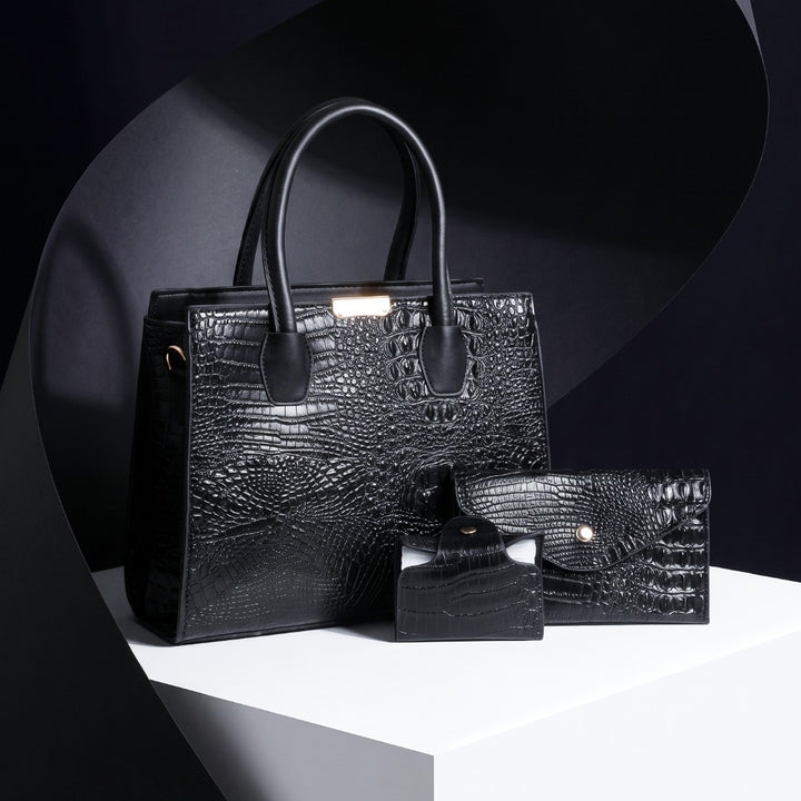 A black crocodile-embossed leather handbag set displayed on a white pedestal against a dark studio background. The set includes a structured tote bag with dual top handles, a matching zip-around wallet, and a small rectangular card case. Gabriella Bag Collection featuring a black crocodile texture handbag wallet and mini purse with polished gold accents Up To 75% Off Retail