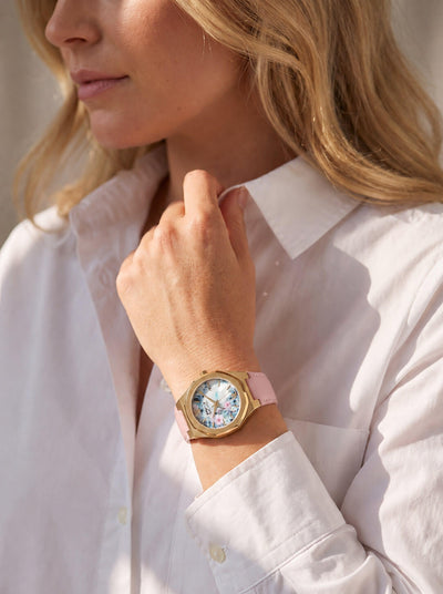 Fleur De Vie Ladies Watch with floral dial and pink strap worn by a woman in a white shirt Up To 75% Off Retail