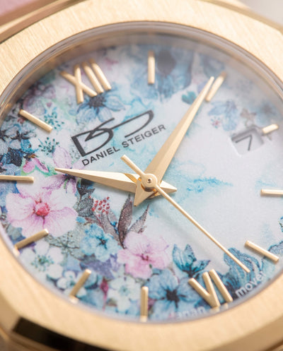 Fleur De Vie Ladies Watch with floral blue and pink dial gold tone case Roman numerals and date window Up To 75% Off Retail