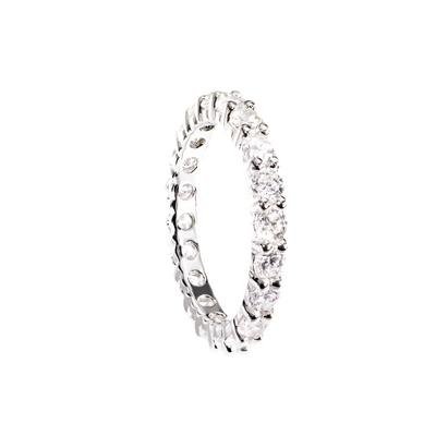 Millionaire Tennis Eternity Ring for female featuring sterling silver band with a continuous row of clear sparkling gemstones, exuding timeless elegance and luxury jewelry appeal.