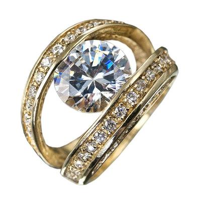 Strata Ring featuring a large central gemstone held by two sterling silver bands with gold plating, each adorned with small sparkling stones, designed for women’s jewelry.