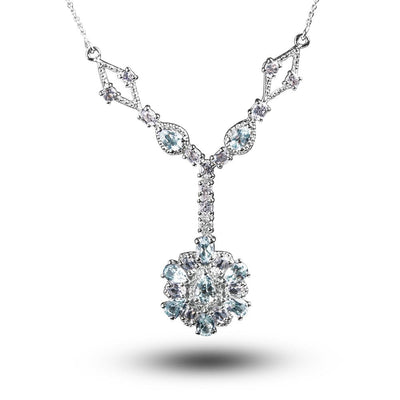 Bonita Topaz Necklace featuring sterling silver with rhodium plating, designed for women, showcasing a delicate arrangement of pear-shaped and round light blue topaz gemstones in an elegant floral pendant style.