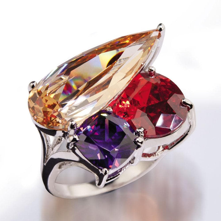 Raindrop Ring featuring a sterling silver band with rhodium plating, adorned with large multicolored gemstones including amber, red, and purple, designed for women.