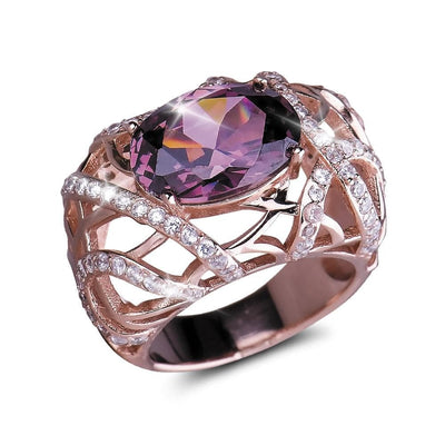 Entwined Rose Gold Ring featuring sterling silver base plated in rose gold with an intricate lattice design, adorned with sparkling clear stones and a large faceted purple gemstone centerpiece.
