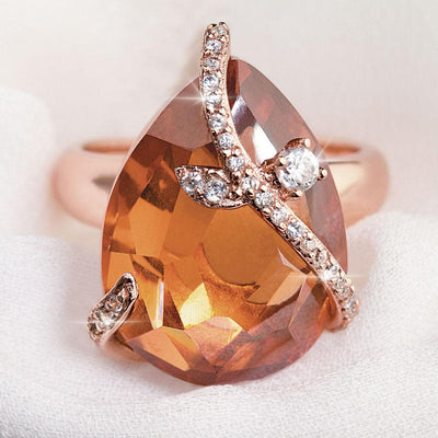 Close-up of a Fire and Ice Ring featuring a large teardrop-shaped gemstone set in sterling silver with rose gold plating, accented with small sparkling stones for a feminine jewelry piece.