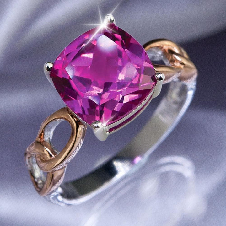 Fuchsia Ring featuring a two-tone sterling silver band accented with a vibrant cushion-cut fuchsia gemstone, designed for women seeking elegant jewelry.