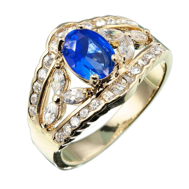 Regency Sapphire Ring featuring a gold-plated sterling silver band with a large oval sapphire center stone surrounded by sparkling clear stones, designed for women’s jewelry.