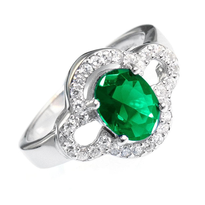 Godiva Ring featuring a sterling silver band with an oval green gemstone centerpiece surrounded by sparkling clear stones, designed for female jewelry enthusiasts.
