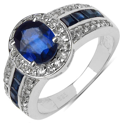 Kyanite Ring featuring a large oval blue kyanite gemstone set in sterling silver with rhodium plating, accented by smaller clear stones and square-cut kyanite on a female band.