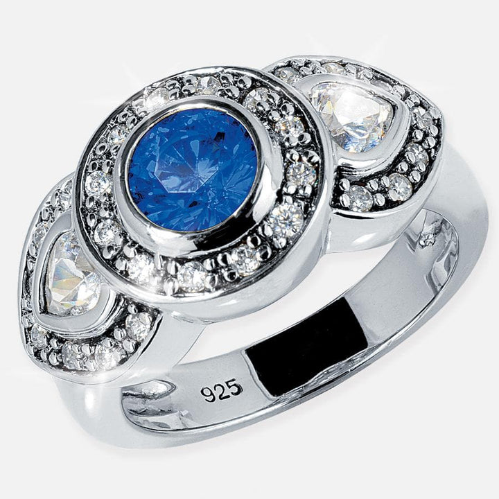 Sterling silver Maharajah Blue Ring for female, plated with rhodium and featuring a central blue gemstone surrounded by clear crystals in an elegant design.