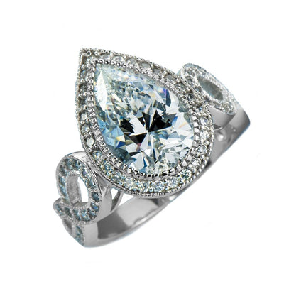 Marie Anna Teardrop Rhodium Ring featuring a sterling silver band with intricate loops and a large teardrop-shaped central gemstone surrounded by smaller sparkling stones.
