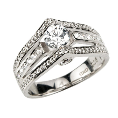 Point Ring crafted in sterling silver with rhodium plating, featuring a female design with a prominent central stone surrounded by smaller sparkling stones.