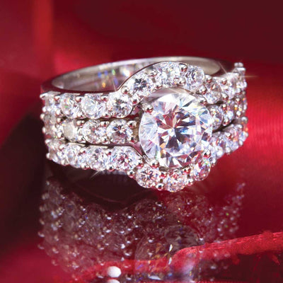 Close-up of a Sterling Silver Stella Stacker Rings set featuring a large central round gemstone surrounded by smaller sparkling stones, designed for female jewelry lovers.