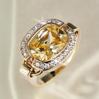 Valenciana Ring featuring a large yellow gemstone centerpiece surrounded by smaller clear stones, crafted in sterling silver with gold plating for women’s elegant jewelry.